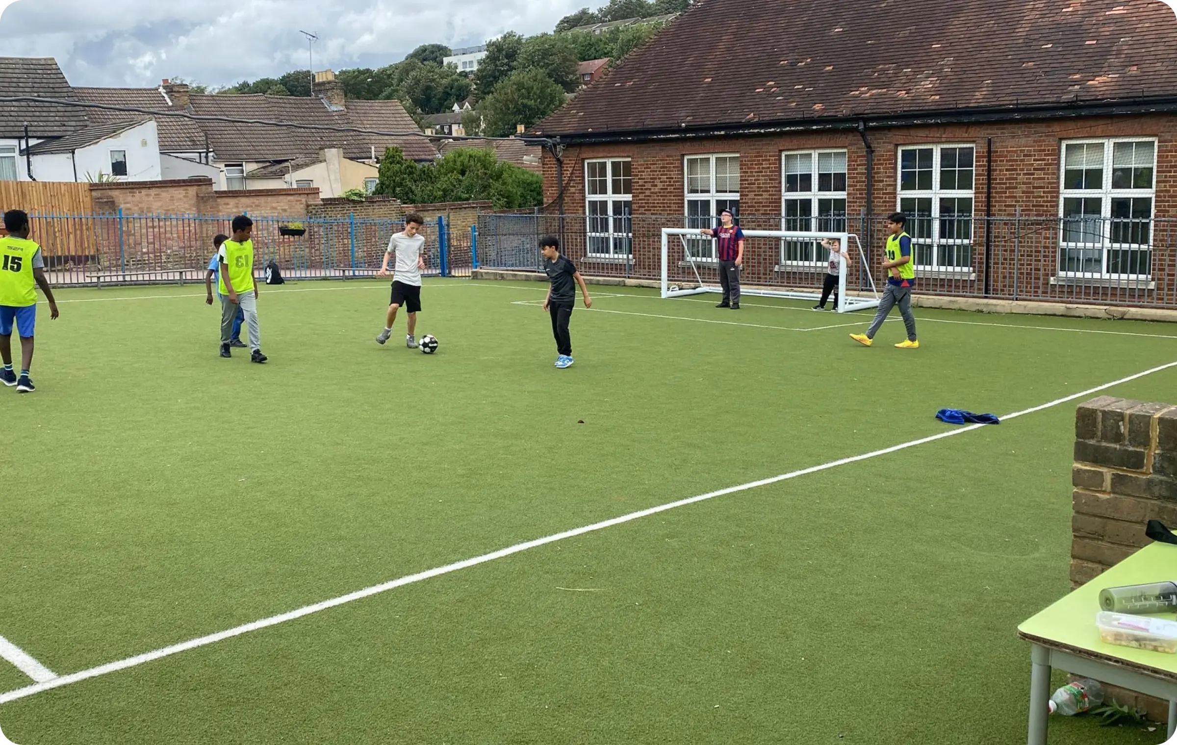 Children playing football together on a field, engaged in an active sports activity