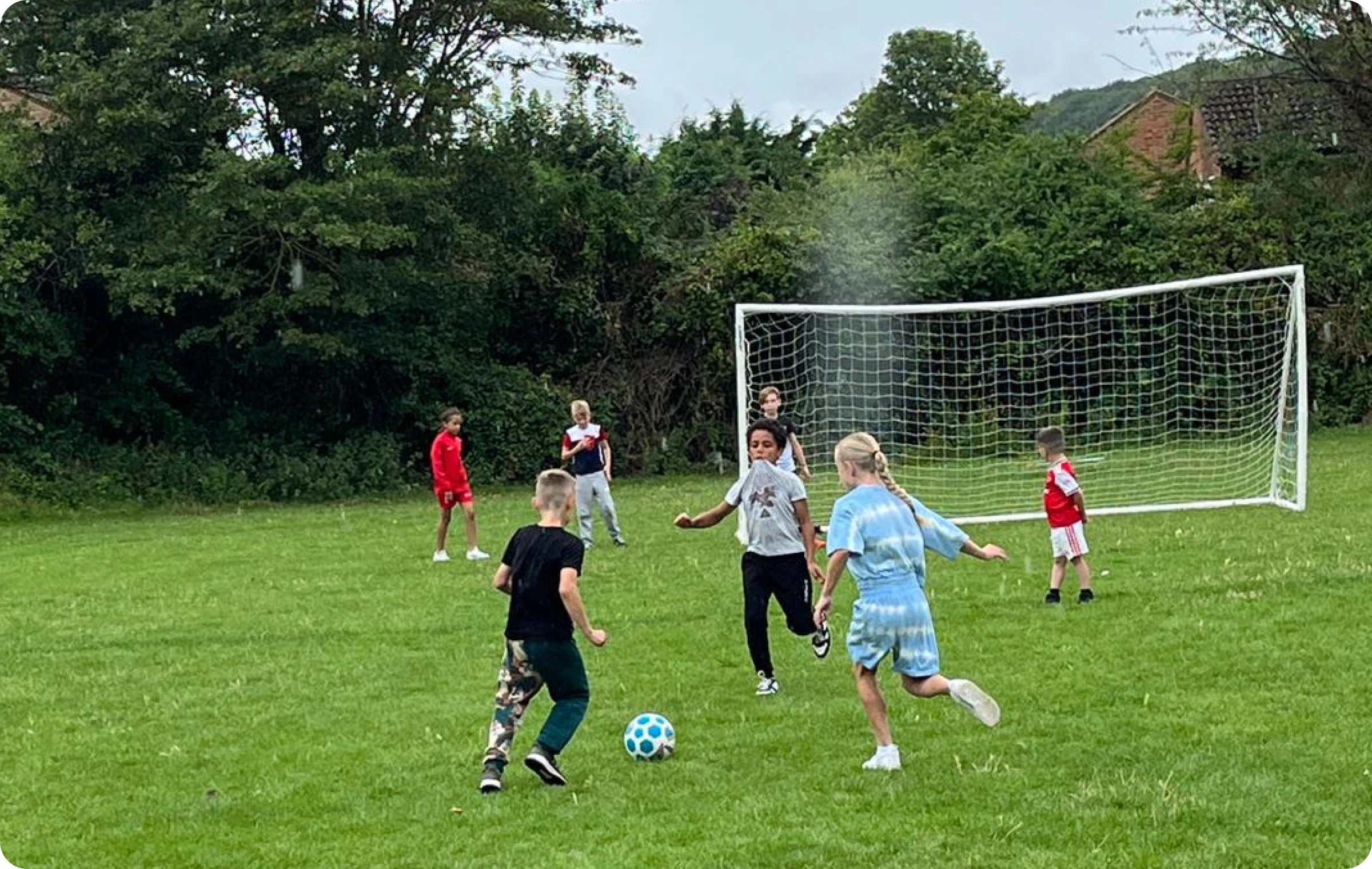 Children celebrating and scoring goals during a sports activity session